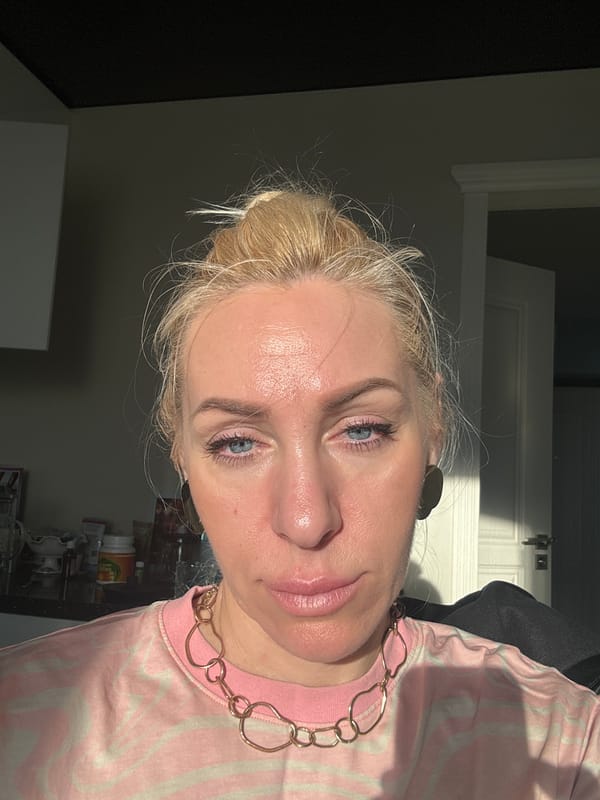Woman eats yogurt in kitchen during afternoon snack time