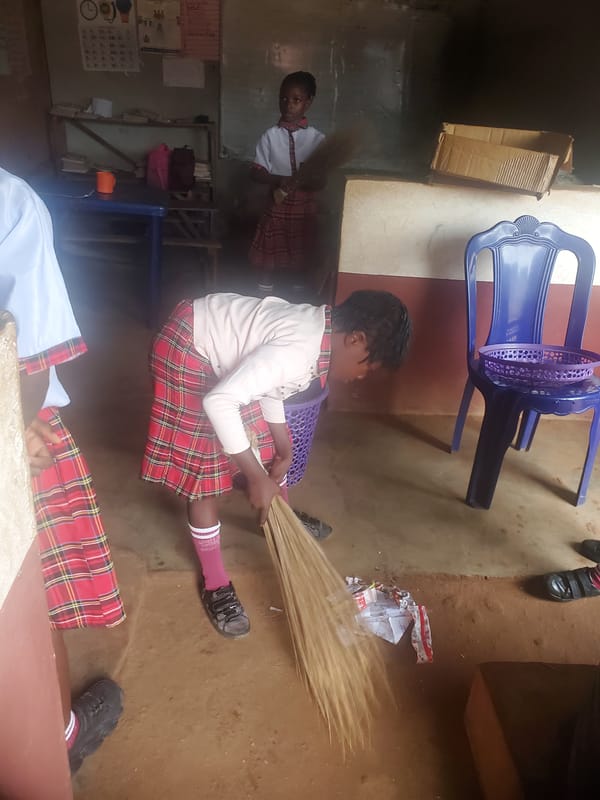 Young person sits with sticks in Ukwu-Abwa, Nigeria