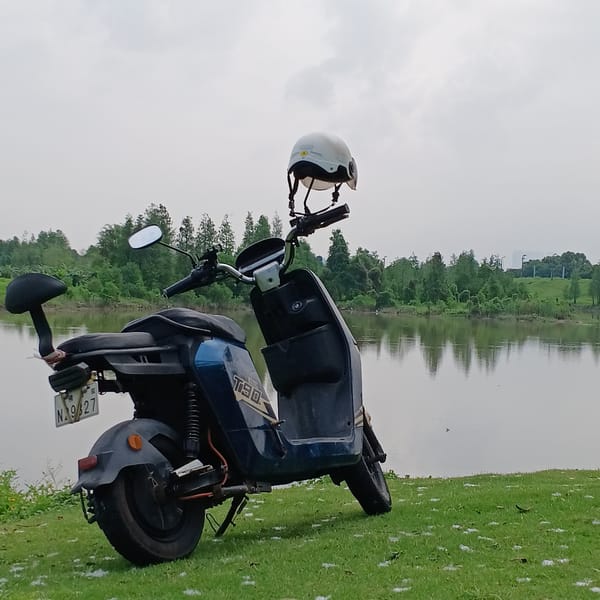 Quiet lakeside moment captured with electric scooter in Shunde