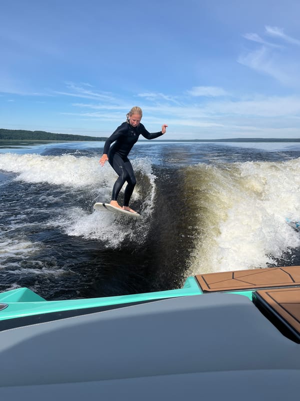 Wake surfing a boat wave on a Russian lake