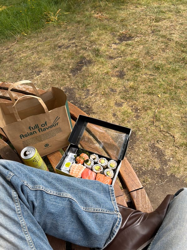 Londoner enjoys takeaway sushi lunch on park bench