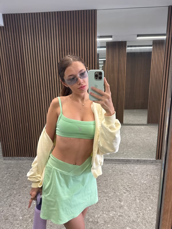 Woman takes mirror selfie at Cyprus gym in athletic wear