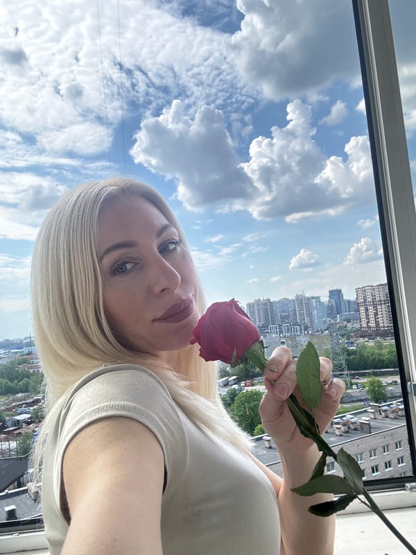Woman poses with red rose in Russia portrait session