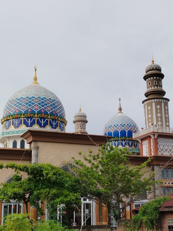 Ornate mosque photographed under overcast skies in Lhokseumawe, Indonesia