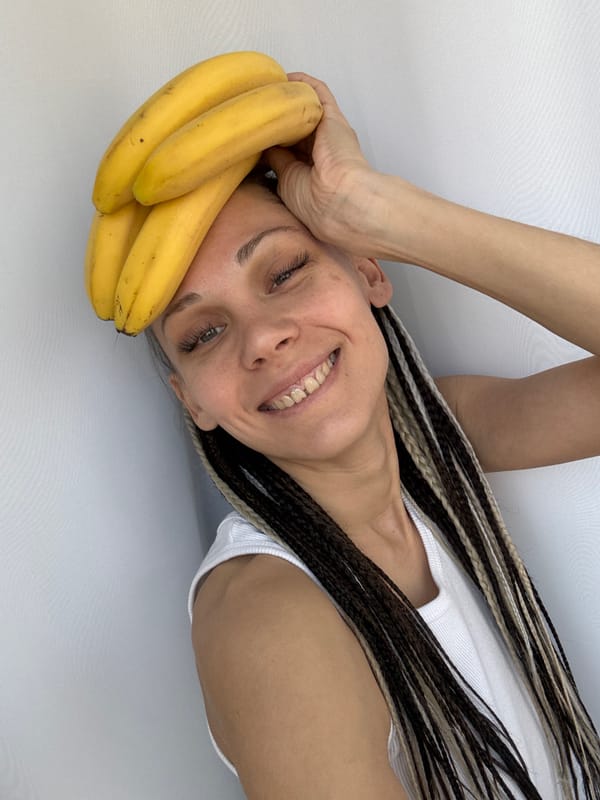 Woman photographed with bananas in playful pose in Rusanovo