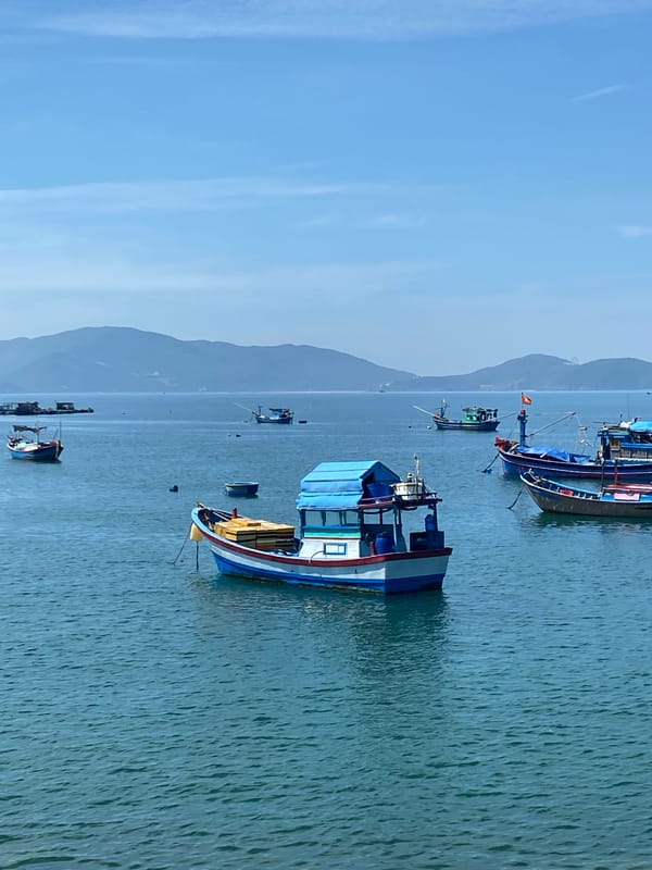 Nha Trang harbor on a calm morning, boats and shoreline