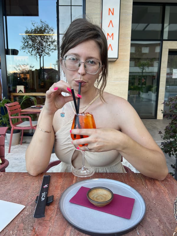 Women dine outdoors in Podgorica, sharing cocktails and chips