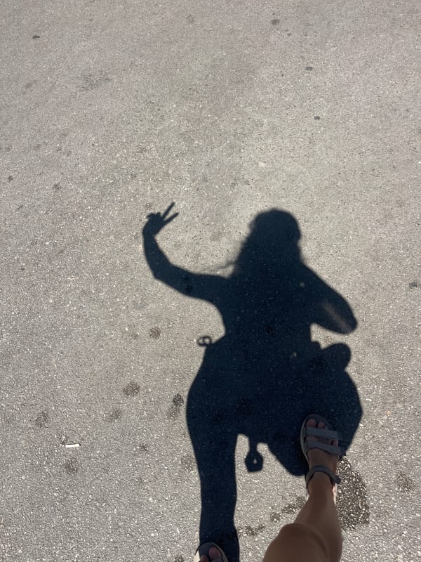 Groceries, a yoga mat, and a peace sign shadow on pavement