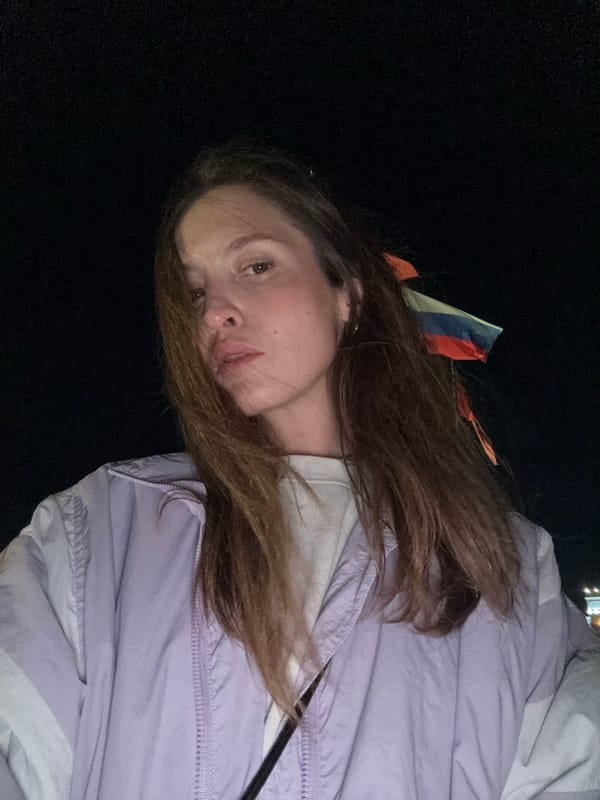 Evening photography session captures woman, trees, Rezanov statue in Krasnoyarsk