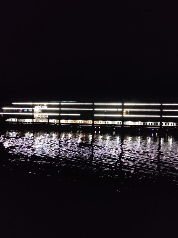 Illuminated passenger ship Mustai Karim observed on dark waters