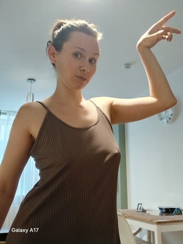 Woman poses, drinks coffee in early morning kitchen moments