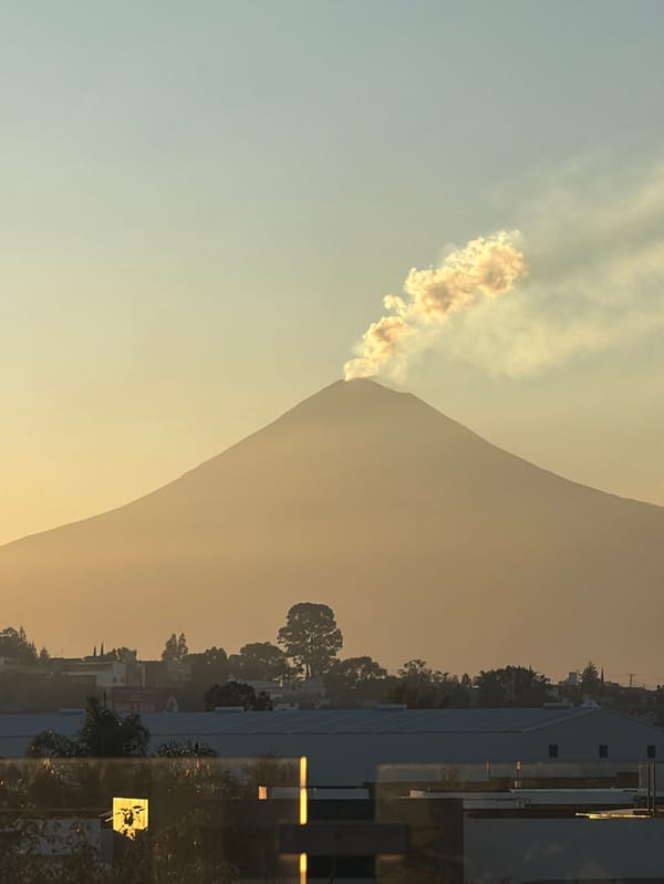 Volcano emits smoke plumes during sunset near Tlaxcalancingo, Mexico