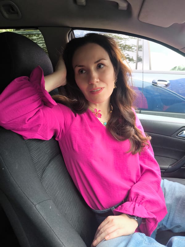 Woman in pink blouse observed in driver's seat, Riga