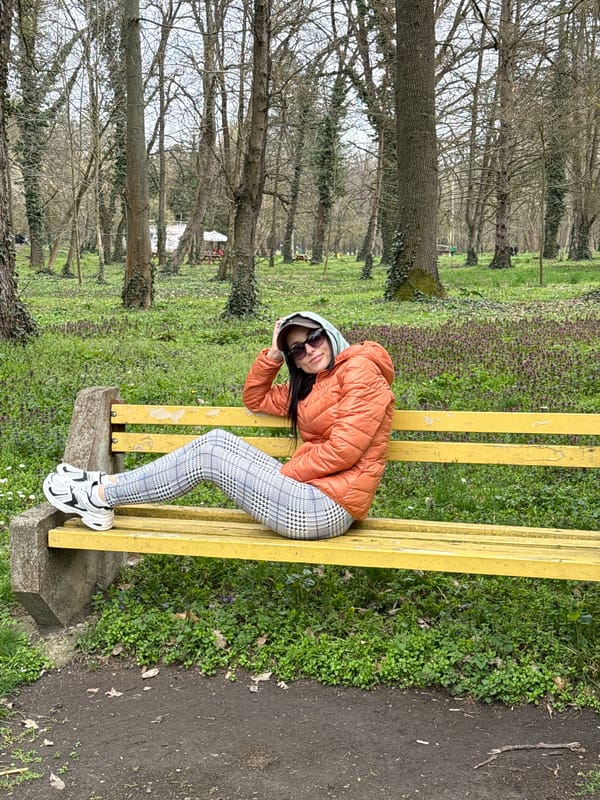 Woman relaxes on park bench in Pleven, Bulgaria