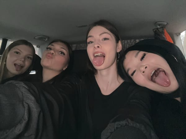 Four women pose for playful group photo in Saint Petersburg