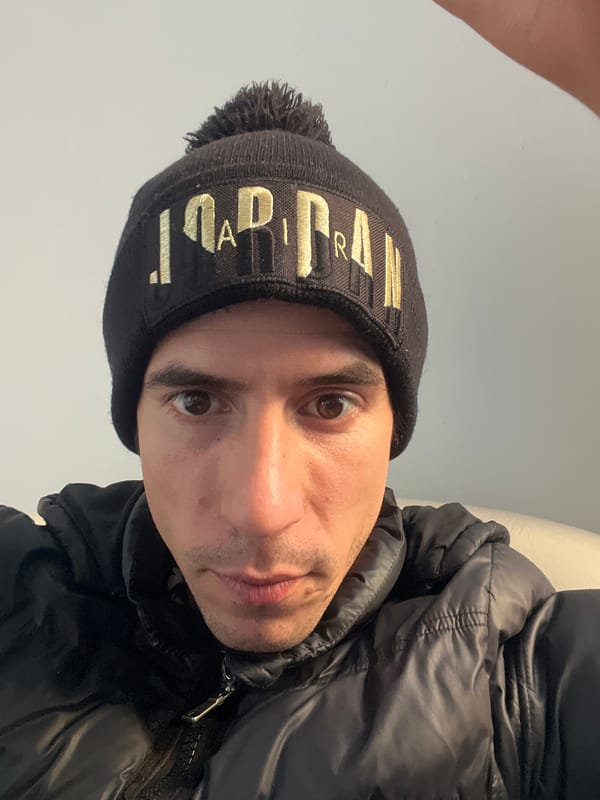 Man in Jordan beanie, black dog captured in Buenos Aires