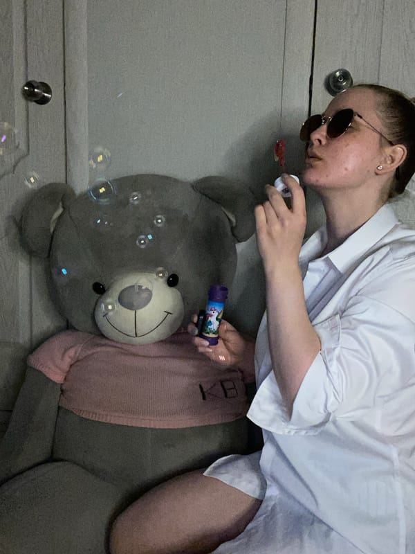 Young woman documents quiet afternoon routine with cat and snacks