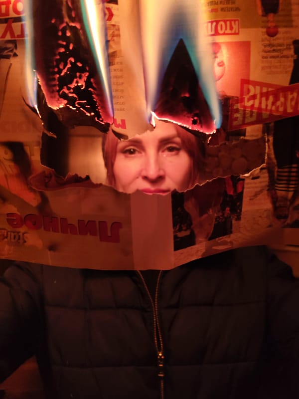 Woman seen through burning holes in Russian newspaper pages