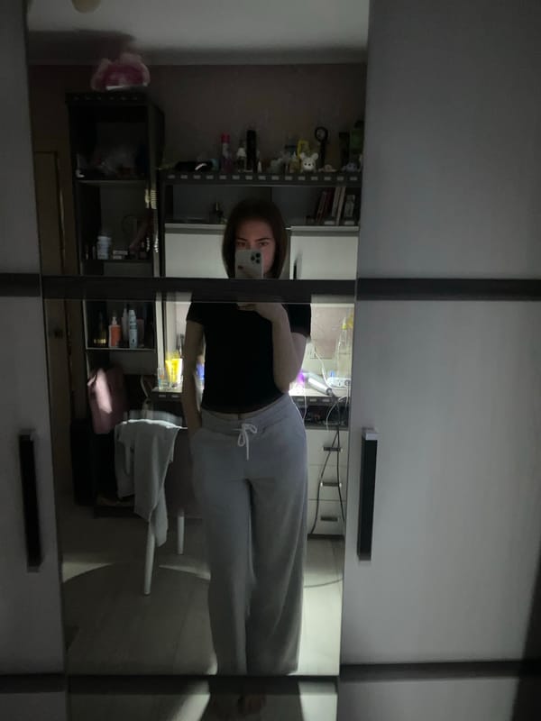 Young woman documents bathroom routine in mirror selfies