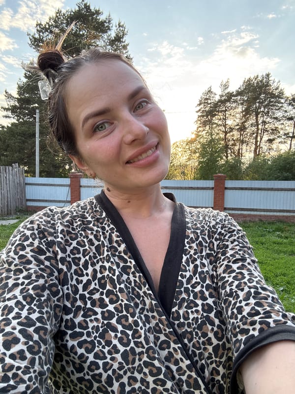 Woman takes selfies with dog in Russian village garden