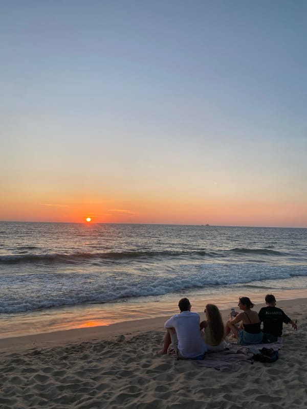 Beachgoers enjoy ocean waves at Choeng Thale, Thailand