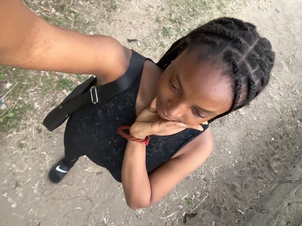 Woman photographed in black outfit on Lokoja dirt path