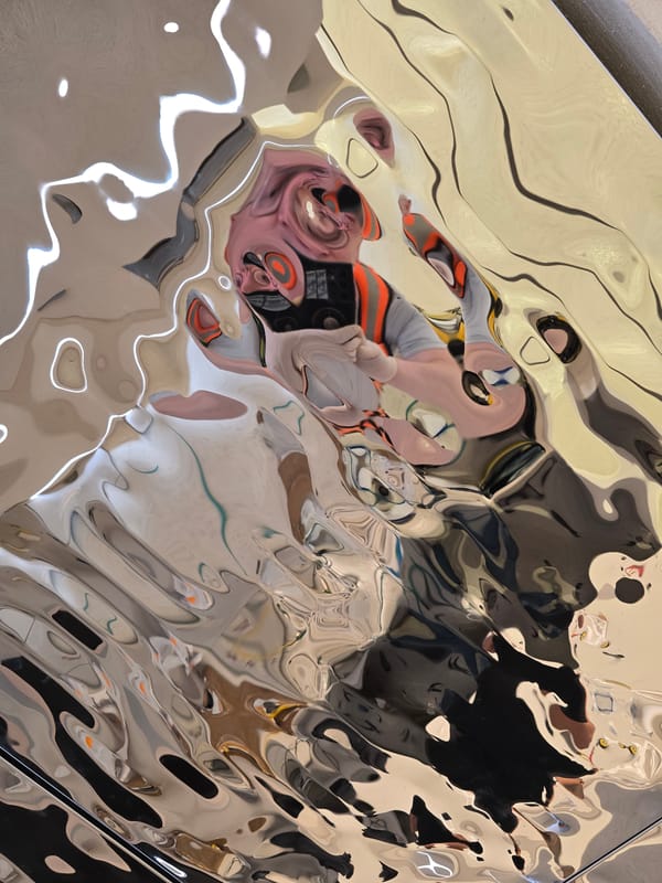 Abstract reflections captured on distorted metallic surface in Jordan