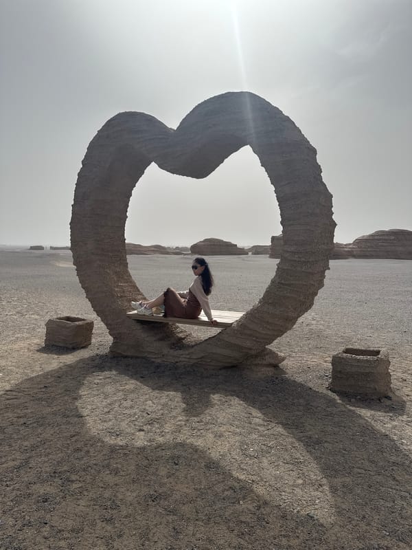 Tourists explore heart sculpture at Dunhuang desert park