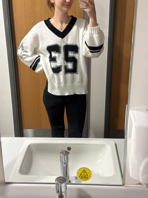 Mirror reflection captured in Ipswich bathroom showing numbered sweater