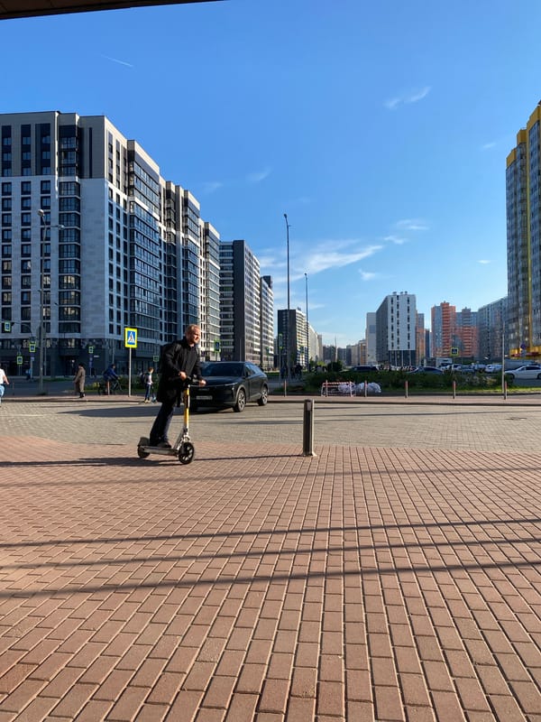 Man rides scooter on sidewalk in Murino residential area
