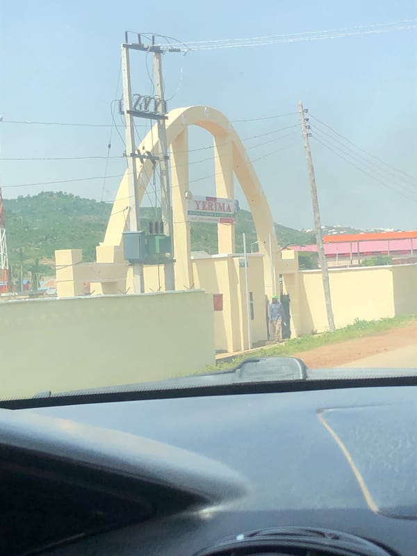 Street view and yellow archway in Jos, Nigeria
