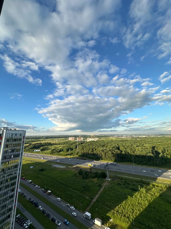 Rooftop views across Kudrovo's modern skyline and highway corridor