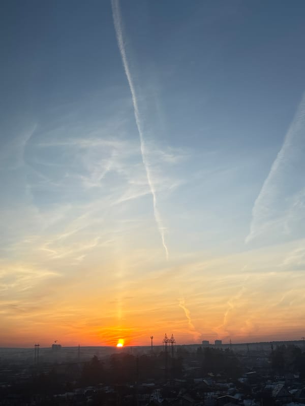 Sunrise sky with contrails observed over Chaikovsky, Russia