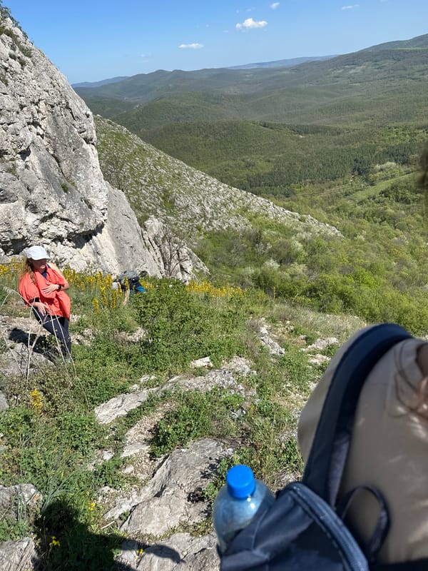Climber rests on rocky hillside near Bilka, Bulgaria