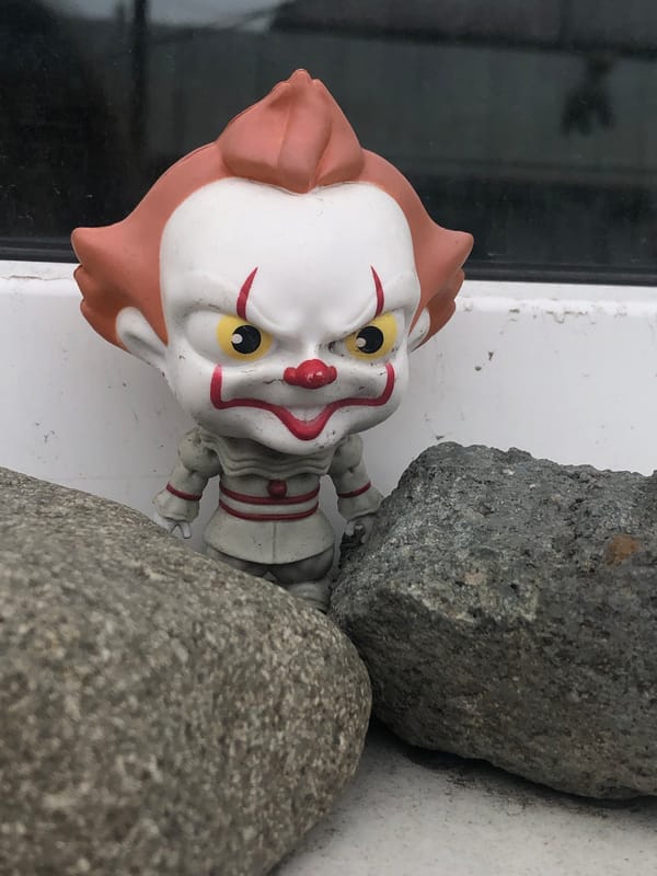 Grey cat and Pennywise figurine share the frame in Yelizovo
