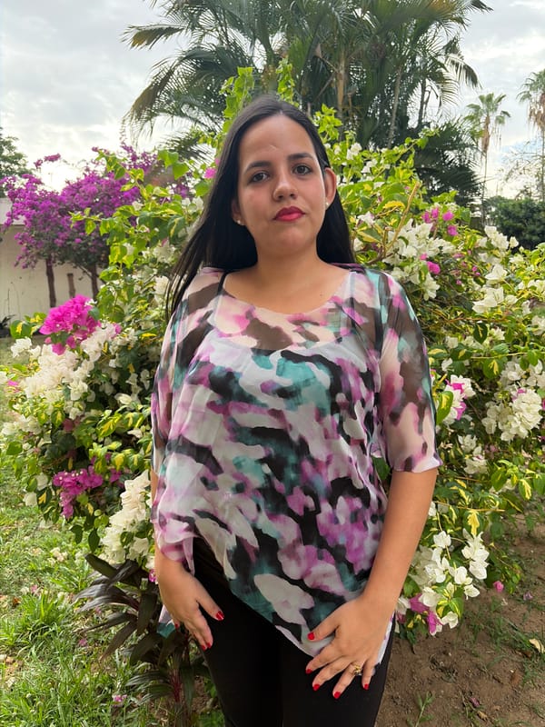 Woman in garden, cat by window observed in Ciudad Guayana