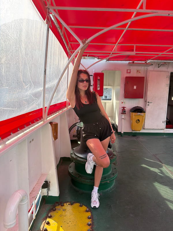Woman poses for photos at Montenegro ferry dock