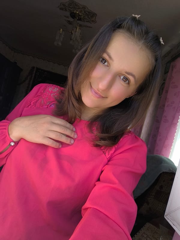 Back-to-back selfies in Anastasivka, pink top and hair clips