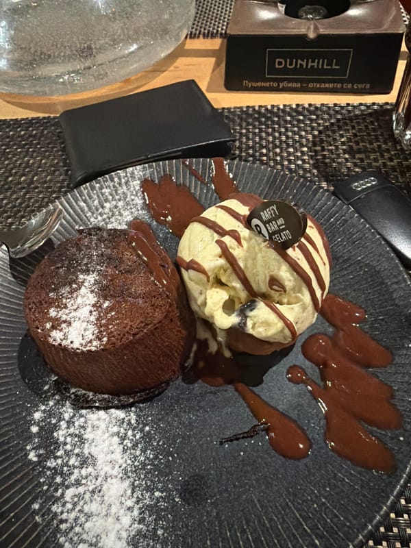 Two men dine together at Plovdiv restaurant with dessert