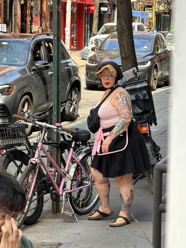 Tattooed woman with pink bicycle spotted on busy NYC streets