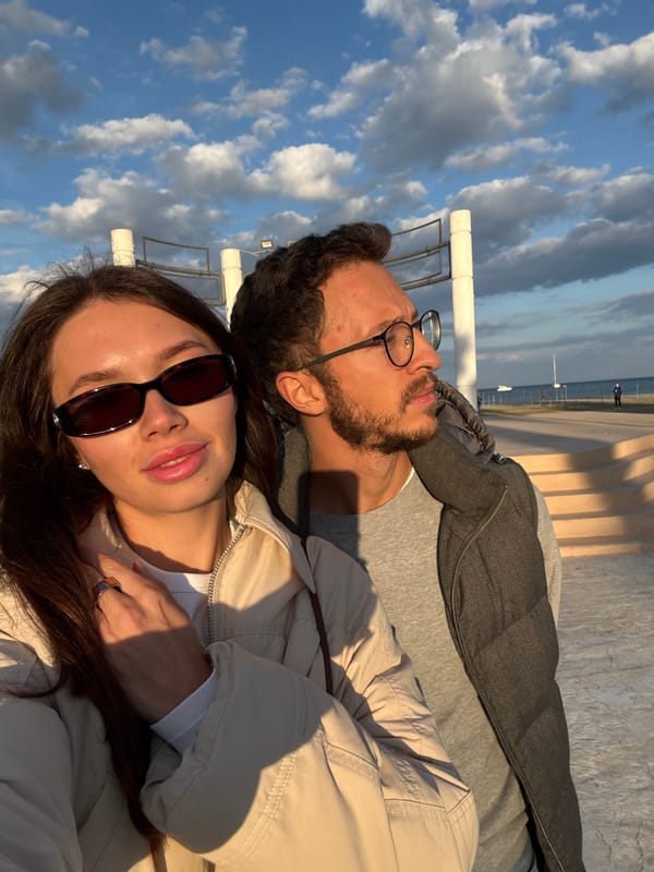 Couple enjoys afternoon stroll along Larnaca beach promenade