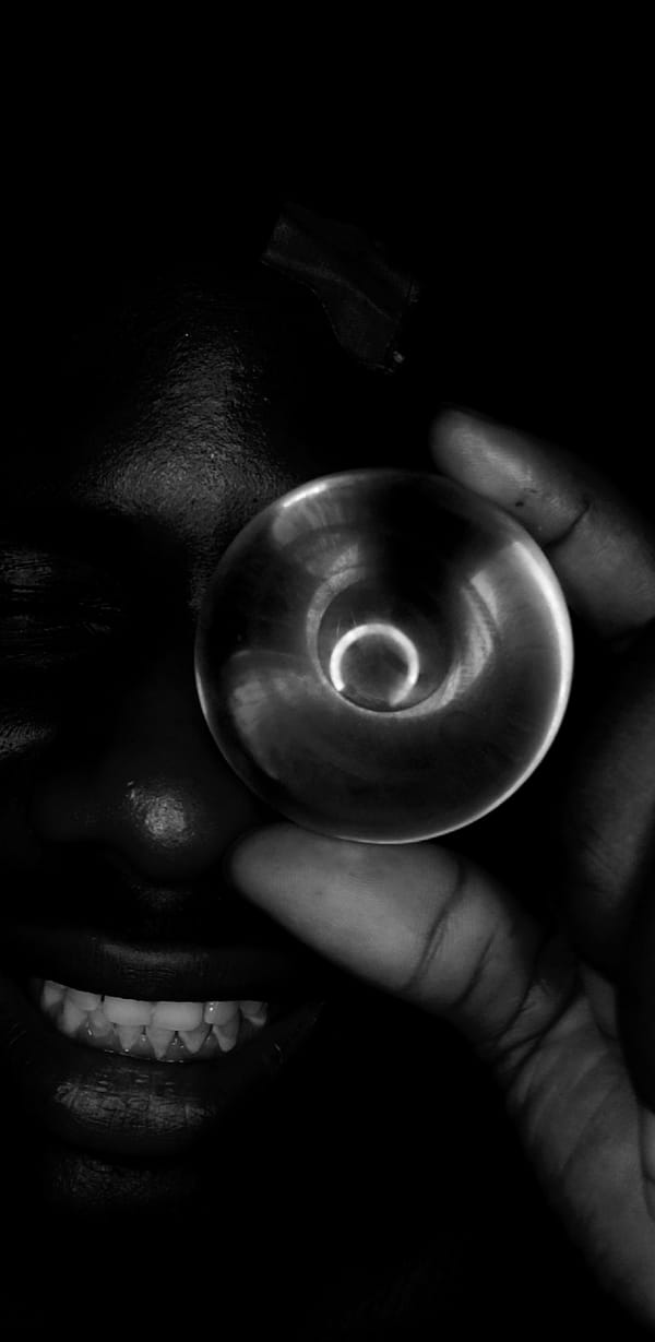Artistic portrait session with transparent sphere captured in Nigeria