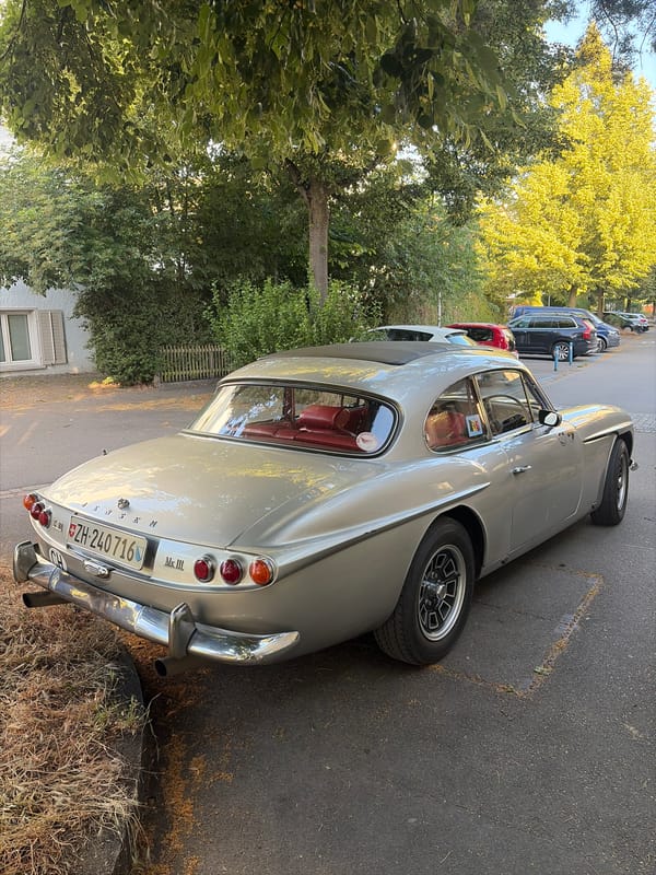 Silver vintage car with red interior parked in Zurich