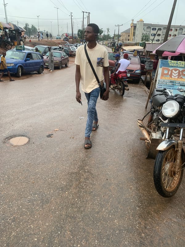 Wet afternoon street life near Shagamu's market district