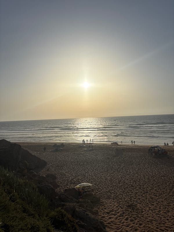 A busy sunny beach day from road to shoreline