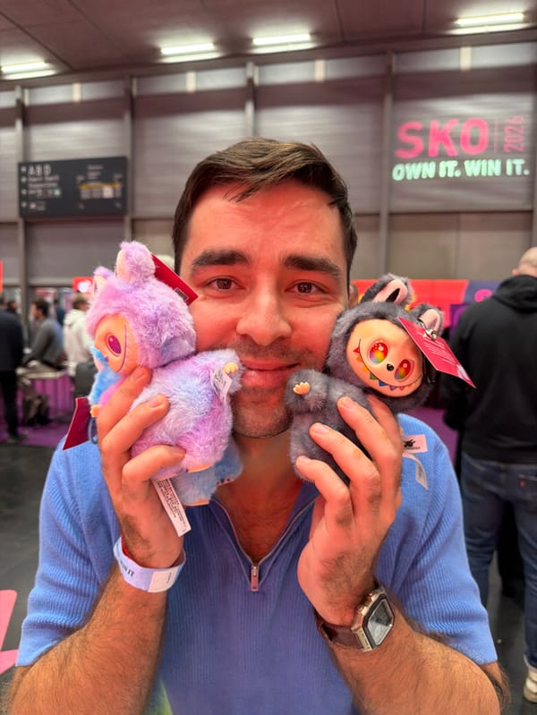 Man holds plush toys near promotional banner in Vienna