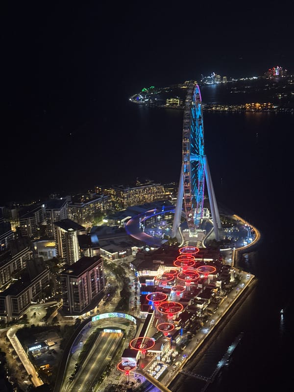 Aerial night footage captures illuminated Dubai cityscape by water