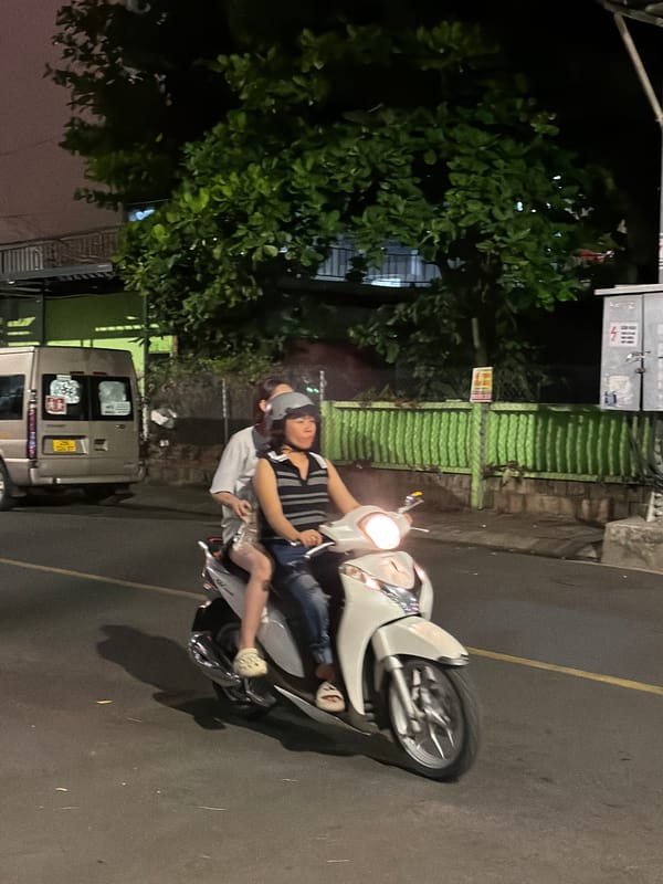 Nha Trang streets at night: motorbikes, bougainvillea, and city life