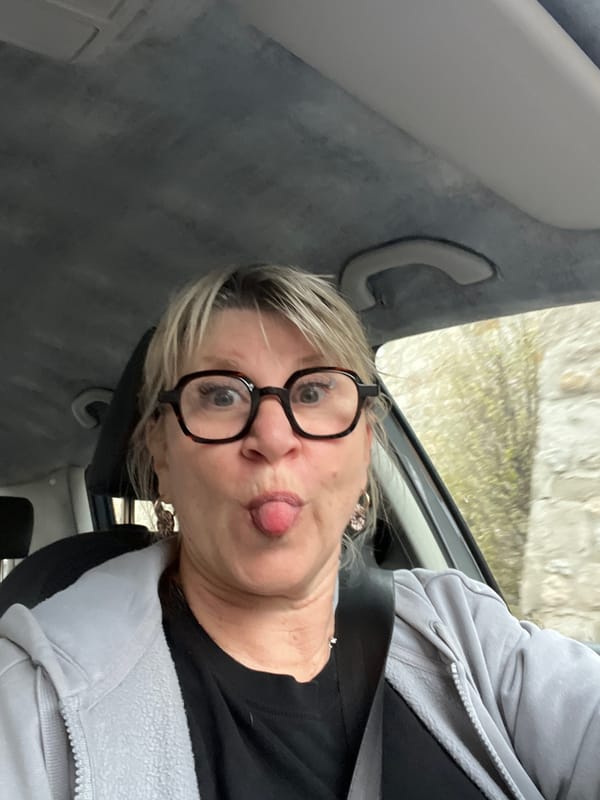 Woman makes playful face during car ride in Saint-Galmier