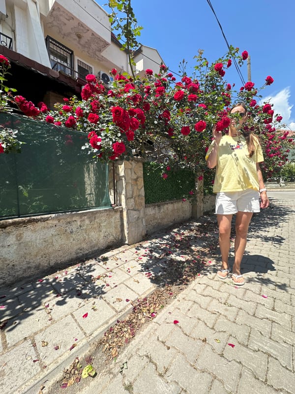 Woman documents morning rose garden walk in Fethiye, Turkey